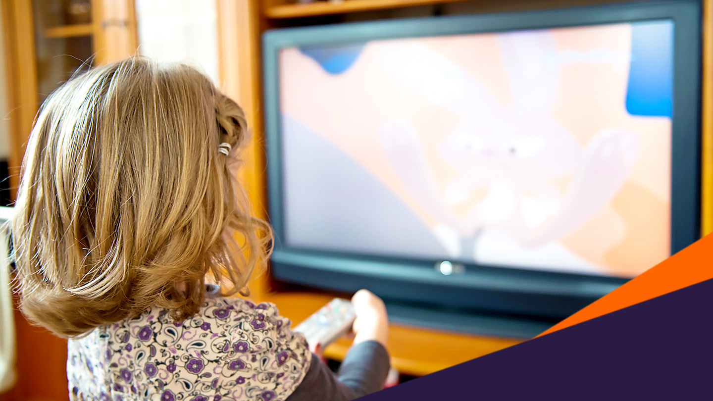 child sitting in front of a television watching tv